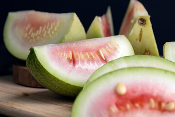 Obraz premium cut small unripe watermelon on a board