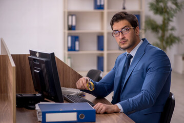 Young male employee working in the office