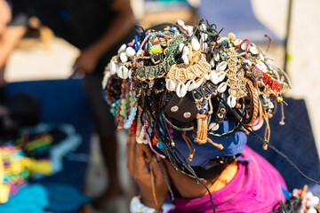 Unknown street vendor sell bracelets on head in local market. Handmade crafts, wide range of goods. Indian culture.