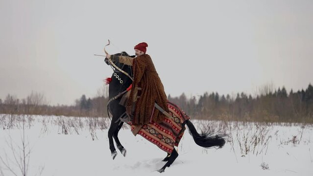 archer with bow riding horse in winter, history of 12 century in eastern Europe and Kievan Rus