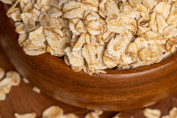 Oat flakes scattered on a wooden surface