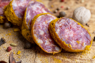 Sliced pork salami with spices and lots of turmeric