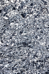 crumpled thin aluminum foil reflecting light