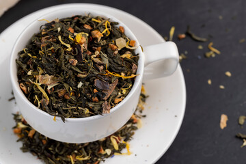 Dry green tea poured into a white mug