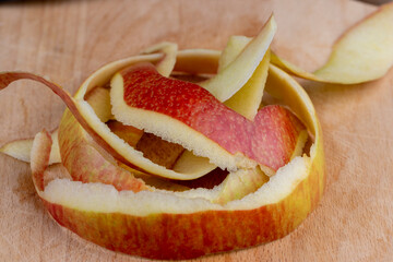 the peel of a peeled apple scattered on the board