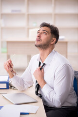 Young male employee working in the office