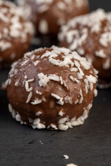 Chocolate candies in the form of balls with milk coconut