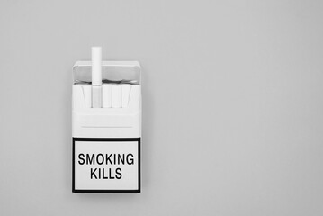 open pack of cigarettes on a gray background