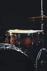 Fototapeta na wymiar Snare drum on a blurred dark background, part of a drum kit.