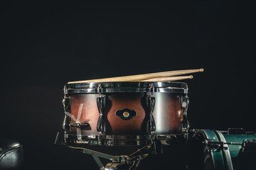 Fototapeta na wymiar Drums on a black background close-up, percussion instrument on stage.