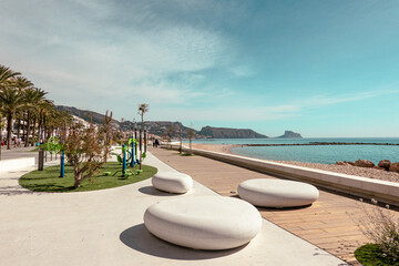 Altea seaside promenade with recreation and active leisure areas on sunny day. Altea - beautiful authentic Spanish village in Alicante Province, Valencian Community, by Mediterranean Sea in Spain - obrazy, fototapety, plakaty