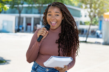 Pretty african american female journalist of radio station or television live on air