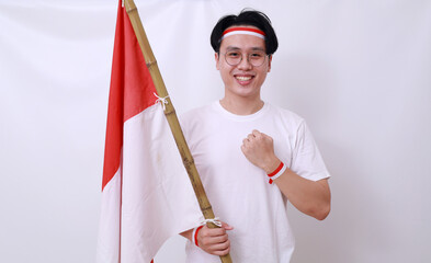 Asian man celebrate Indonesia Independence Day on 17 August by holding Indonesian flag. Isolated