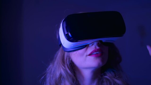 Woman in Virtual Reality Headset playing at home