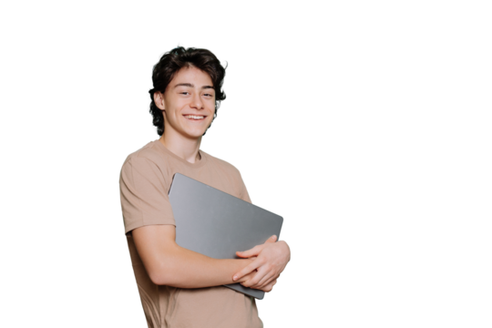 Handsome Italian cheerful student guy carrying laptop looks at camera broad smiles stands against transparent background with copy space for ad. Mockup, youth and students life. Boy with new computer.