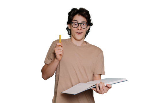 Excited caucasian teen boy in glasses and beige t-shirt holds book and pen, got idea stands against transparent background with amazed face expression. Creative American guy got solution. Education