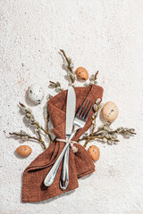 Easter table setting with eggs, rabbits and willow. Traditional festive symbols, greeting card