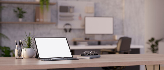 Close-up image of a digital tablet mockup on a wood table in modern office workspace.