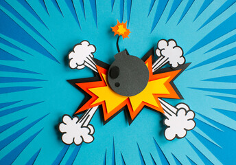 Handmade colorful paper cutting bomb. Pop art and comic style. On blue background. Speech bubble with bomb. 