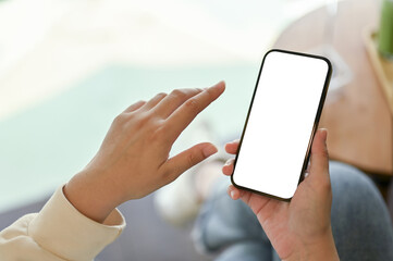 Close-up image of a female relaxing in a cafe and using her smartphone.