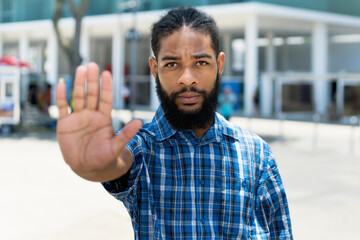 Black man gesturing stop against racism
