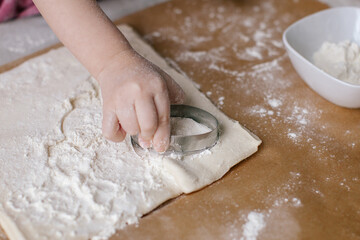 Little girl is making a egg. Easter preparation. Baking sheet. Family time.