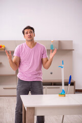 Young male contractor cleaning the house