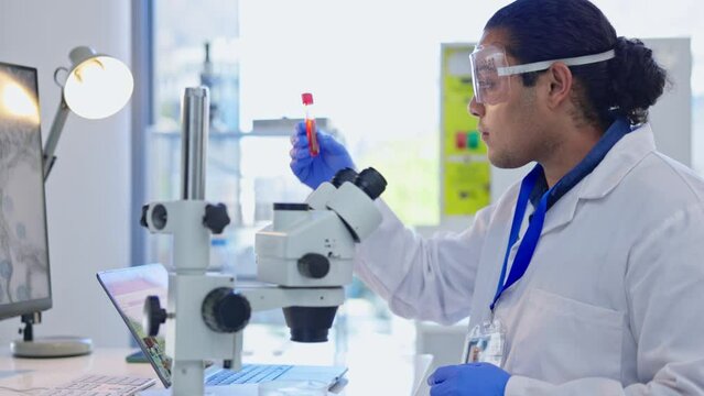 Science, microscope and man with blood sample in laboratory for analysis, dna results and medical study. Healthcare, biotechnology and male scientist with test tube for vaccine, virus and research