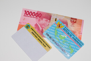 KTP and NPWP and money on white background