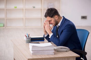 Young male employee working in the office