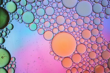 multi colored oil circles on the water, colorful background