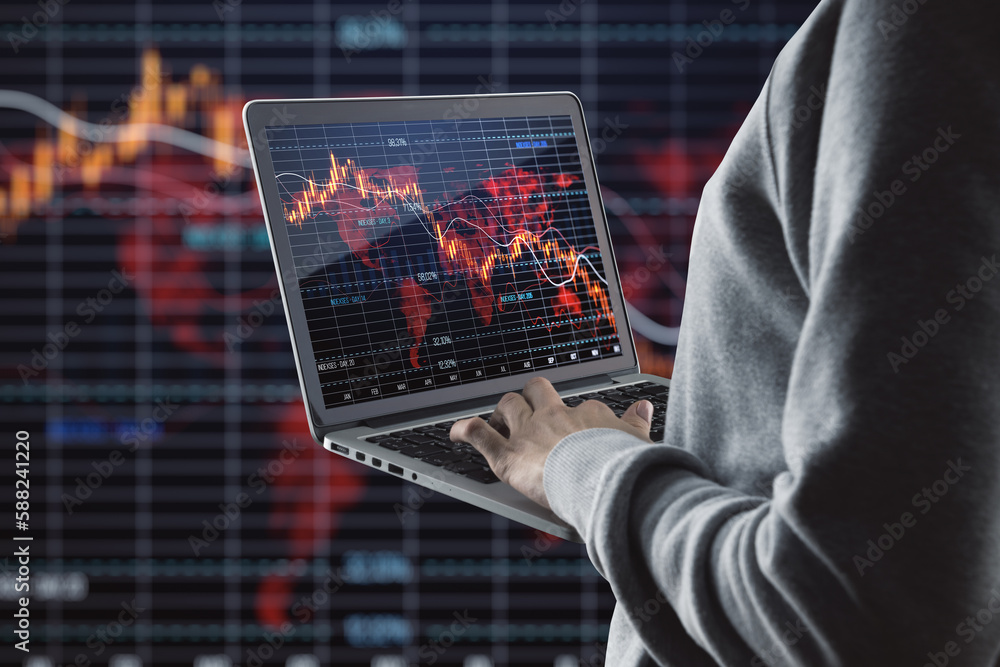 Poster close up of hands using laptop with falling red crisis forex chart on dark grid background. recessio