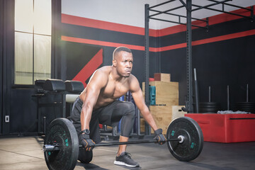 Fitness man lifting weights in gym fitness, Muscular man working out in gym doing exercises with barbell weight