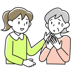 不安げな顔で話すシニア女性と耳を傾ける若い女性