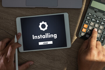 man installing Software Update On Mobile Phone And Laptop digital technology communication