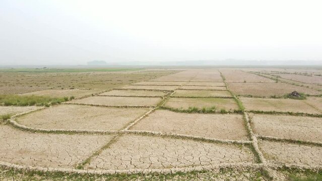 An aerial view of arid drought farmland on a farm in Bangladesh. Changing climate and sustainable land use and crop rotation in agriculture.