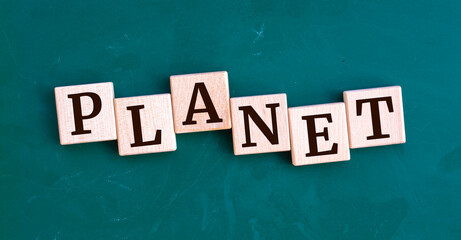 Planet message sign on a wooden cubes on chalkboard background.