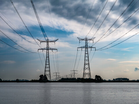 Pylons and power lines over Ramsdiep canal of Zwarte Meer lake, Netherlands
