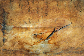 Close-up texture of wooden boards with cracks faded from time.