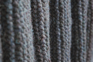 Folds of gray knitted fabric. Knitted texture background.