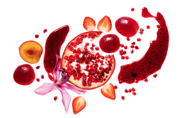 Broken slice of pomegranate, orchid, strawberry, plum on red jam splatter