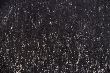 Clinging sand to the dark synthetic material