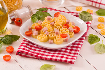 Ruote pasta with tomato and ham.