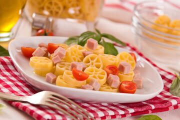 Ruote pasta with tomato and ham.