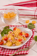 Ruote pasta with tomato and ham.