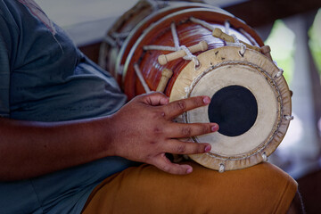 Grown man playing dolak drum, traditional percussion instrument, player, drummer