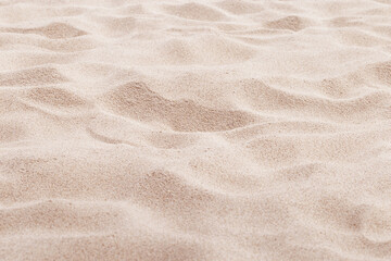 Fototapeta na wymiar Fine Sand texture natural surface. Close up of sand on shore sea, white waves dunes, pink neutral color, minimal nature aesthetics wallpaper. Sandy beach for background, selective focus