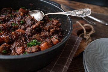 Braised meat with carrots in a pot