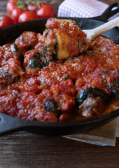 Zucchini roulades with minced meat filling and tomato sauce. Italian involtinis. 