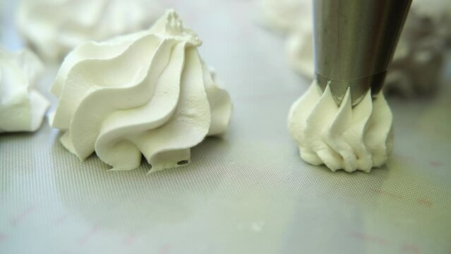 woman makes marshmallows with a pastry bag. Taken in close-up